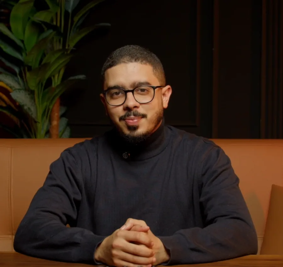 Ayman Kafi seated in his warmly lit studio